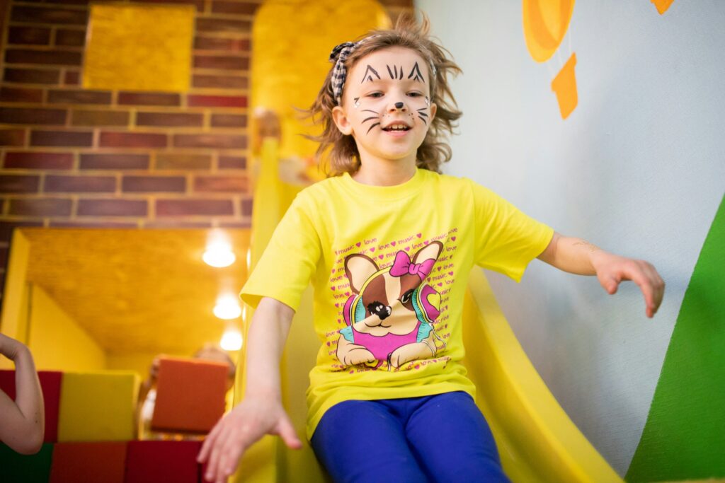 Dziewczynka zjeżdżająca na zjeżdżalni - sala zabaw w Krakowie, mity o salach zabaw